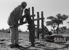 This is an image of Chief Lekolwane Sebogodi and his grandson pumping water in Braklaagte. Image also included in the Land Act virtual exhibition.