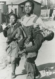 The death of Hector Pieterson This is Sam Nzima's well-known black and white photograph of the dead body of Hector Pieterson being carried by Mbuyisa Makhuba alonside his sister during the Soweto uprising on 16.06.1976. This photograph was digitised by Africa Media Online (AMO) in 2009. Included in SAHA exhibition kit and virtual exhibition - 'The Future is Ours: Commemorating Youth in the Struggle'
