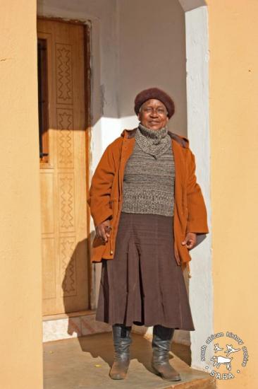 Elsie Motsusi in the doorway of her new home, Braklaagte, June 2013. (Photographer: Gille de Vlieg)
