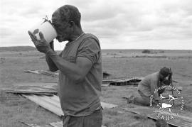 This black and white photograph of Daniel Molefe quenching his thirst during rebuilding in Mogopa was taken by Gille de Vlieg on 15 December 1988. Included in SAHA Land Act Project report, 2014.