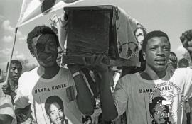 This black and white photograph of the funeral of Themba Dlamini of Driefontein was taken by Gille de Vlieg in May 1990. Included in SAHA Land Act Project report, 2014.