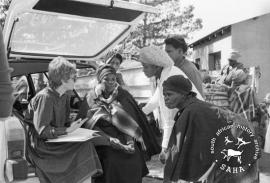 This black and white photograph of a member of the Black Sash assisting Driefontein residents with pension was taken by Gille de Vlieg in May 1983. Included in SAHA Land Act Project report, 2014.