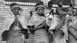 This is a black and white photograph of Mogopa students in a school play prayer in Onderstepoort for guests was taken by Gille de Vlieg on 02 February 1989. Included in SAHA Land Act Project report, 2014.