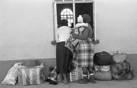 This is a black and white image of women peeking through a church window in Braklaagte. Image is also included in the Land act virtual exhibition