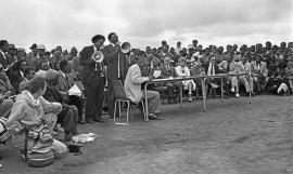 This is a black and white image of Enos Mabuza addressing the crowd in Driefontein. Image included in the LA virtual exhibition
