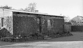 This is a black and white image viewing the Mkhize homestead, taken by Gille de Vlieg. Image also used in the LA Virtual exhibition