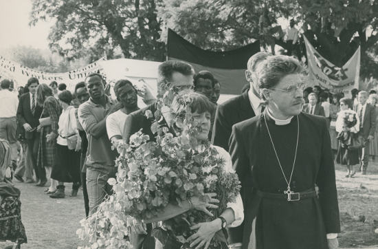 Maggie Friedman and Rev. Paul Verryn walking to the grave-side. Maggie Friedman and Rev. Paul Verryn walking to the grave-side.