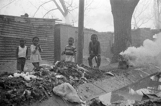 Children playing around burning rubbish in the street,   Soweto, Gauteng, 14 July, 1989, Gille de Vlieg Collection, AL3274_G24.2