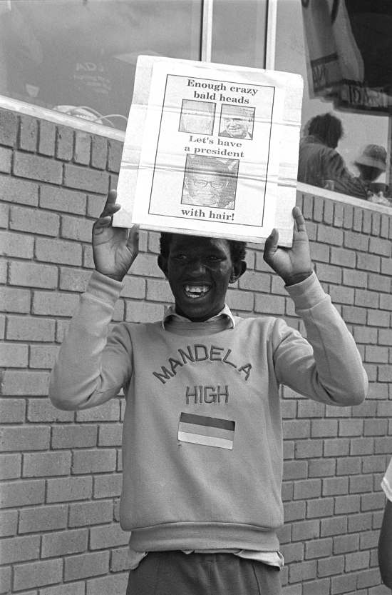 Placard: Let's have a president with hair, Soweto, Gauteng, 1989-10-29. Photograph by Gille de Vlieg. Archived as SAHA collection AL3274_G.36.6