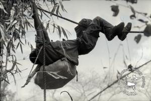 A ZPRA cadre crossing a river in flood using a rope