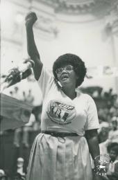 This black and white photograph of Dorothy Nyembe at a protest meeting was taken by Myron Peters, date unknown.
